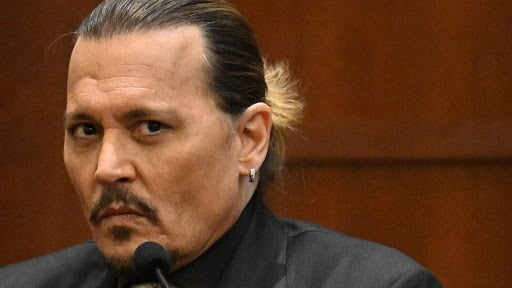 Actor Johnny Depp denies ever hitting a woman